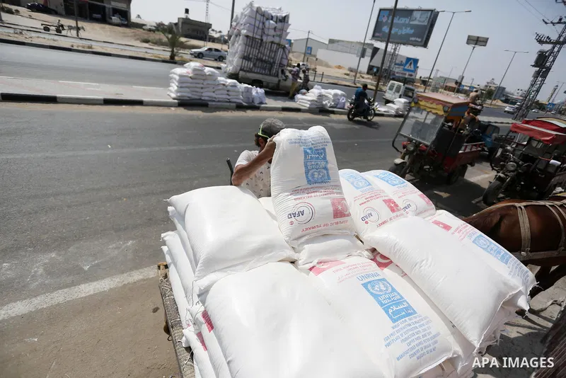 Palestinians stand outside an aid distribution center run by United Nations Relief and Works Agency (UNRWA) in Deir al-Balah in the center of Gaza Strip on September 1, 2018. The United States on Friday halted all fundin...