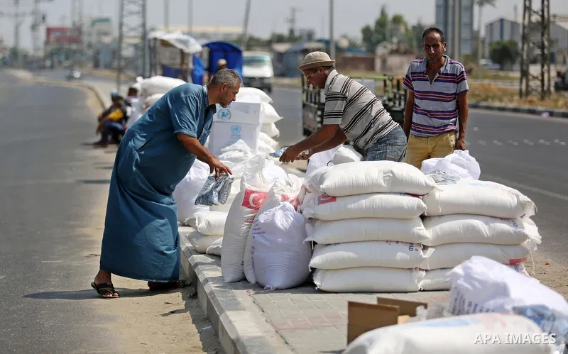 Palestinians stand outside an aid distribution center run by United Nations Relief and Works Agency (UNRWA) in Deir al-Balah in the center of Gaza Strip on September 1, 2018. The United States on Friday halted all fundin...