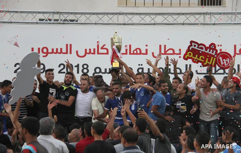 Palestinian Shabab Rafah players celebrate with the trophy after beating Shabab Khan Younis during Super Cup soccer match, at Palestine Stadium, in Gaza City on September 1, 2018. Photo by Mahmoud Ajour