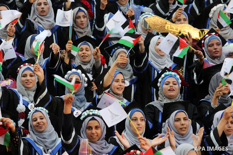Palestinian students celebrate during their graduation ceremony at al-Aqsa University in Khan Younis in the southern of Gaza strip on Sep. 01, 2018. Photo by Atia Darwish