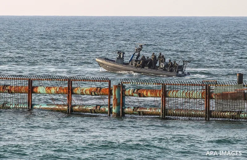 Israeli military speedboats is seen where Palestinians protest on a beach along the Gaza sea barrier on the border with Israel near Kibbutz Zikim, north of Beit Lahia in the northern Gaza Strip on September 2, 2018. Phot...