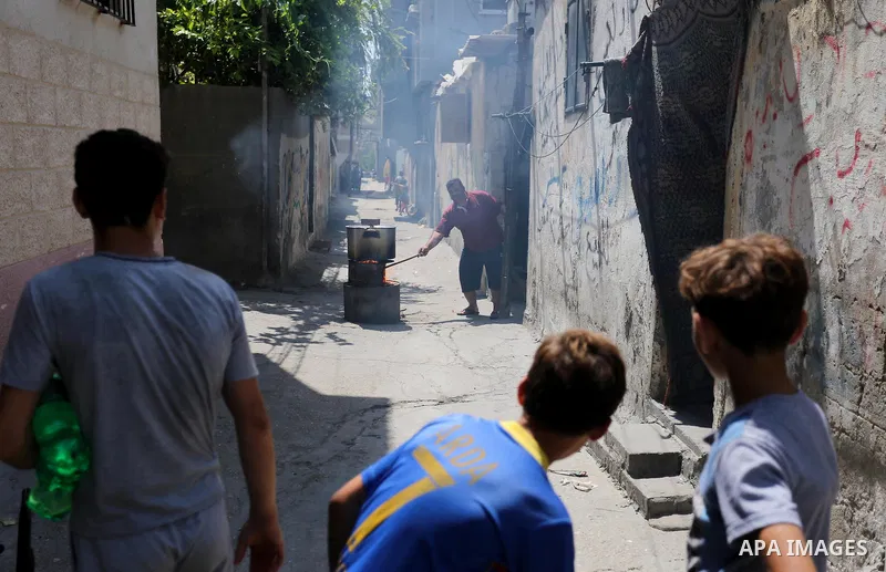 Palestinian refugees stand in a street at Al-Shati refugee camp, in Gaza City on September 3, 2018. The United States halted all funding to United Nations' agency that helps Palestinian refugees. State Department spokesw...
