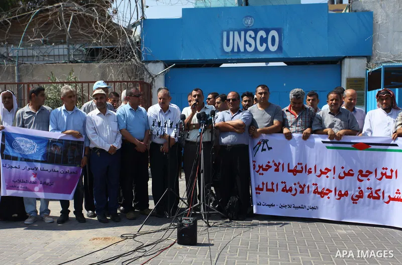 Palestinians hold banners during a protest against a U.S. decision to cut aid in front of the headquarter United Nation "UNSCO", in Gaza city on September 4, 2018. The United States halted all funding to United Nations'...