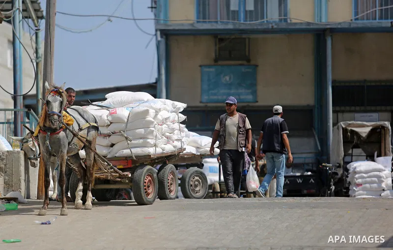 Palestinians receive food aid at an aid distribution center run by United Nations Relief and Works Agency (UNRWA) in Khan Younis in the southern Gaza Strip on September 4, 2018. The United States halted all funding to Un...