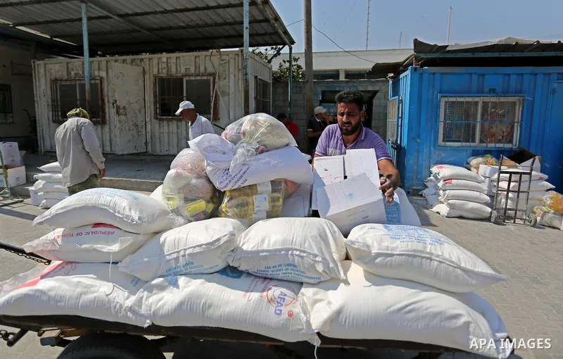 Palestinians receive food aid at an aid distribution center run by United Nations Relief and Works Agency (UNRWA) in Khan Younis in the southern Gaza Strip on September 4, 2018. The United States halted all funding to Un...