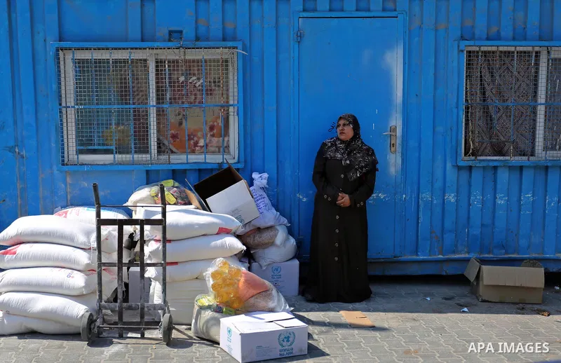 Palestinians receive food aid at an aid distribution center run by United Nations Relief and Works Agency (UNRWA) in Khan Younis in the southern Gaza Strip on September 4, 2018. The United States halted all funding to Un...