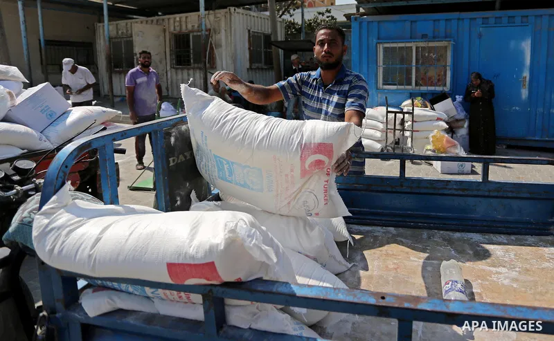 Palestinians receive food aid at an aid distribution center run by United Nations Relief and Works Agency (UNRWA) in Khan Younis in the southern Gaza Strip on September 4, 2018. The United States halted all funding to Un...