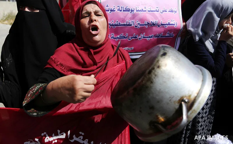 A Palestinian woman drums of a cooking pot during a protest against U.S. decision to cut aid to United Nations Relief and Works Agency (UNRWA) in Khan Younis in the southern Gaza Strip on September 4, 2018. The United St...