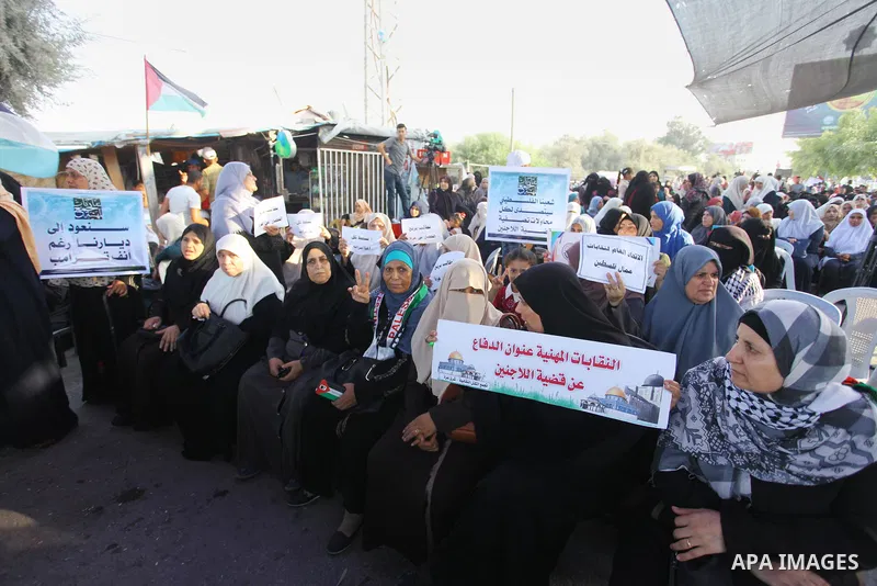 Palestinians take part during a protest against the United States decision to stop funding and backing the United Nations agency for Palestinian refugees (UNRWA) at the Erez crossing with Israel in the northern Gaza Stri...
