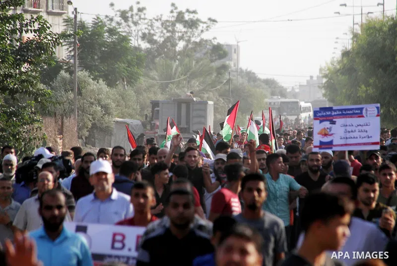 Palestinians take part during a protest against the United States decision to stop funding and backing the United Nations agency for Palestinian refugees (UNRWA) at the Erez crossing with Israel in the northern Gaza Stri...