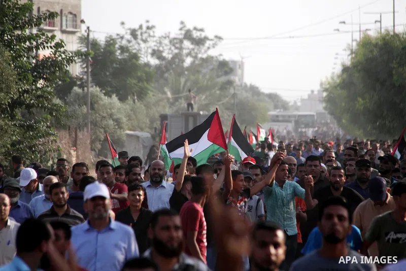 Palestinians take part during a protest against the United States decision to stop funding and backing the United Nations agency for Palestinian refugees (UNRWA) at the Erez crossing with Israel in the northern Gaza Stri...