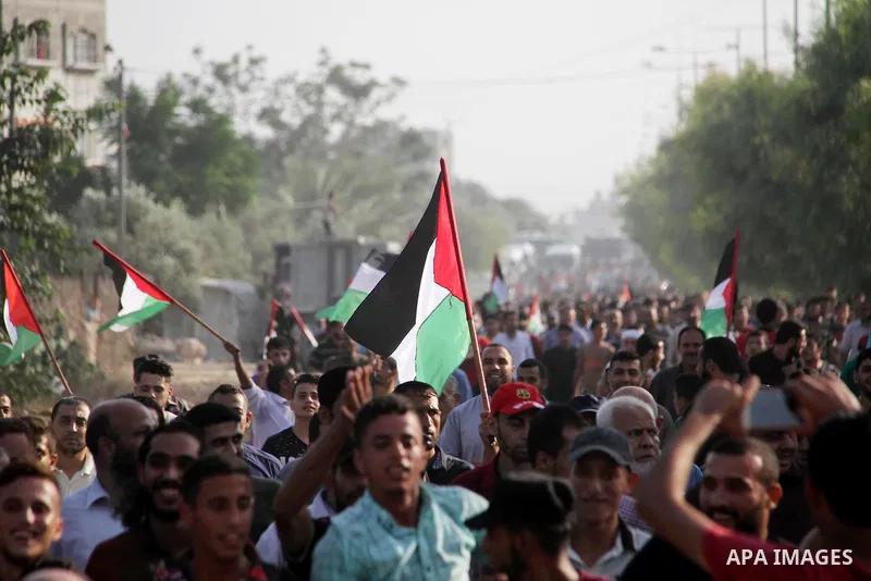 Palestinians take part during a protest against the United States decision to stop funding and backing the United Nations agency for Palestinian refugees (UNRWA) at the Erez crossing with Israel in the northern Gaza Stri...