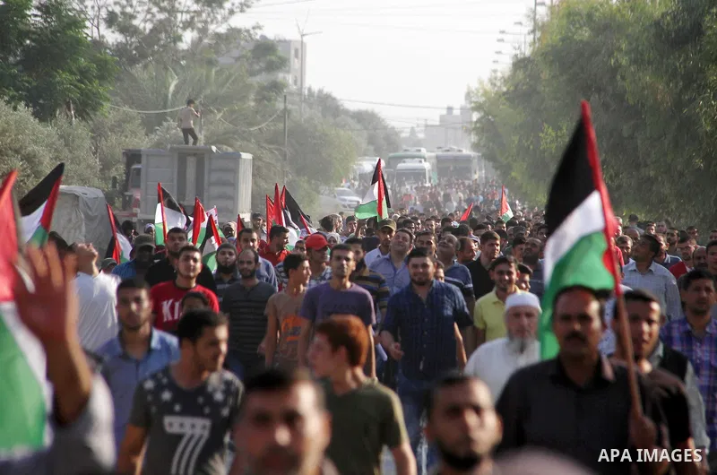 Palestinians take part during a protest against the United States decision to stop funding and backing the United Nations agency for Palestinian refugees (UNRWA) at the Erez crossing with Israel in the northern Gaza Stri...