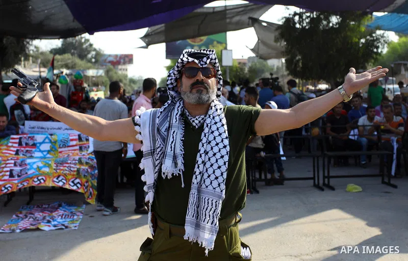 Palestinians take part during a protest against the United States decision to stop funding and backing the United Nations agency for Palestinian refugees (UNRWA) at the Erez crossing with Israel in the northern Gaza Stri...