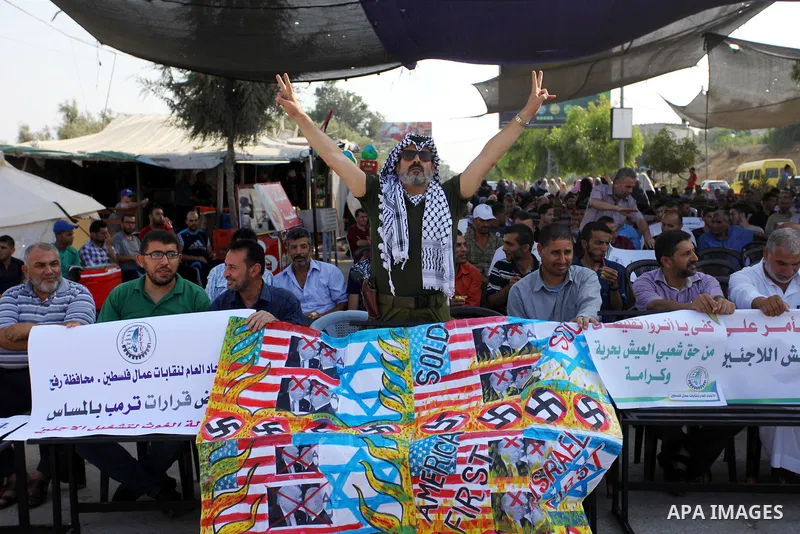 Palestinians take part during a protest against the United States decision to stop funding and backing the United Nations agency for Palestinian refugees (UNRWA) at the Erez crossing with Israel in the northern Gaza Stri...