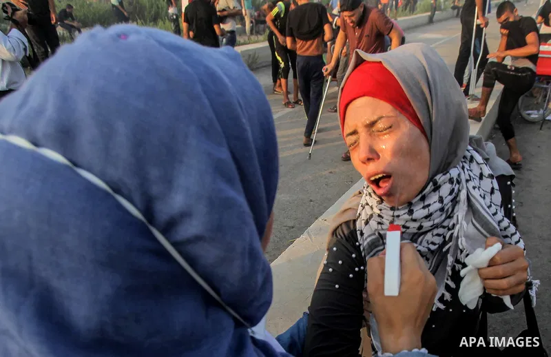 Palestinians gather during clashes with Israeli troops following a protest against the United States decision to stop funding and backing the United Nations agency for Palestinian refugees (UNRWA) at the Erez crossing wi...