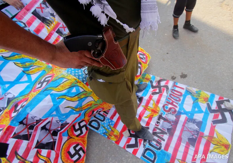 Palestinians take part during a protest against the United States decision to stop funding and backing the United Nations agency for Palestinian refugees (UNRWA) at the Erez crossing with Israel in the northern Gaza Stri...
