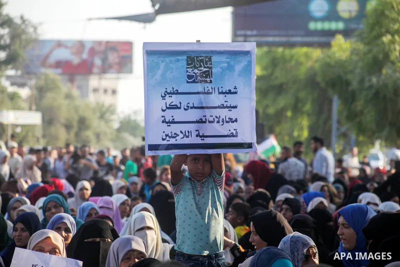 Palestinians take part during a protest against the United States decision to stop funding and backing the United Nations agency for Palestinian refugees (UNRWA) at the Erez crossing with Israel in the northern Gaza Stri...