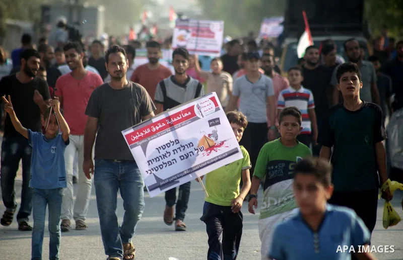 Palestinians take part during a protest against the United States decision to stop funding and backing the United Nations agency for Palestinian refugees (UNRWA) at the Erez crossing with Israel in the northern Gaza Stri...