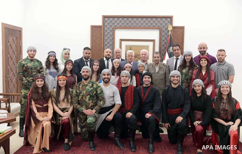 Palestinian President Mahmoud Abbas meetswith the Palestinian Folklore Ensemble, in the West bank city of Ramallah, on Sept. 06, 2018. Photo by Thaer Ganaim