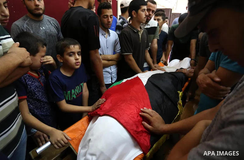 Relatives of Palestinian Hamas militant Abdul Rahim Abbas ,42, who was killed in an unexplained explosion mourn over his body during his funeral, in Gaza city, on Sept. 06, 2018. Photo by Ashraf Amra