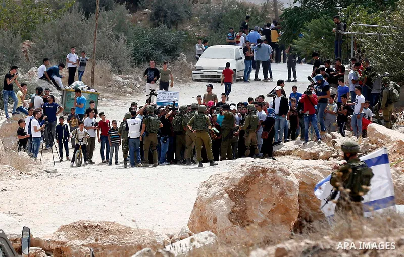 Palestinian protesters take part during a demonstration against the closure of a road since 18 years by the Israeli army in the West Bank village of Khirbat Qalqas, south of Hebron, on September 7, 2018. Photo by Wisam H...
