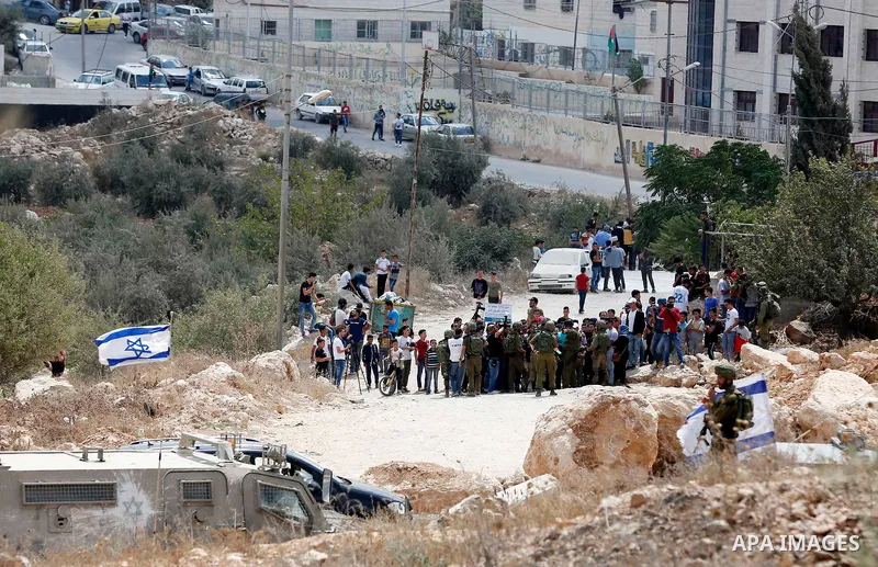 Palestinian protesters take part during a demonstration against the closure of a road since 18 years by the Israeli army in the West Bank village of Khirbat Qalqas, south of Hebron, on September 7, 2018. Photo by Wisam H...