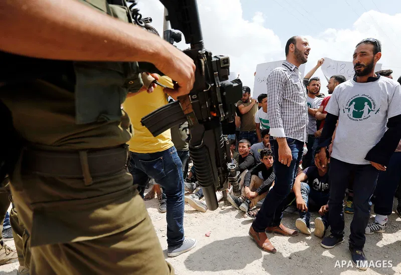 Palestinian protesters take part during a demonstration against the closure of a road since 18 years by the Israeli army in the West Bank village of Khirbat Qalqas, south of Hebron, on September 7, 2018. Photo by Wisam H...