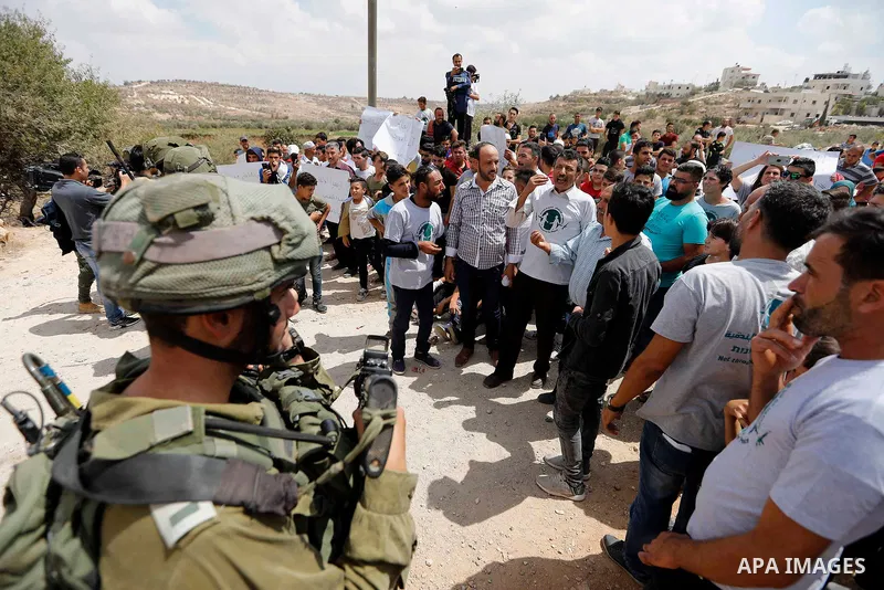 Palestinian protesters take part during a demonstration against the closure of a road since 18 years by the Israeli army in the West Bank village of Khirbat Qalqas, south of Hebron, on September 7, 2018. Photo by Wisam H...