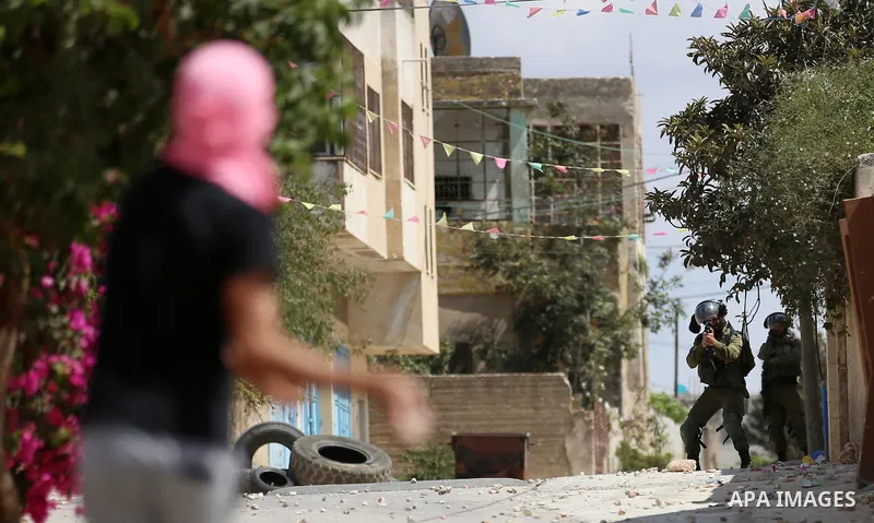 Israeli forces take position during clashes with Palestinian protesters following a weekly demonstration against the expropriation of Palestinian land by Israel in the village of Kfar Qaddum, near the West Bank city of N...