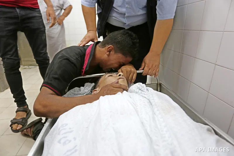 Relatives of Palestinian teenager Belal Khafaja, who was killed by Israeli forces during clashes in tents protest at the Israel-Gaza border, mourn over his body at a hospital in Rafah in the southern Gaza Strip on Septem...