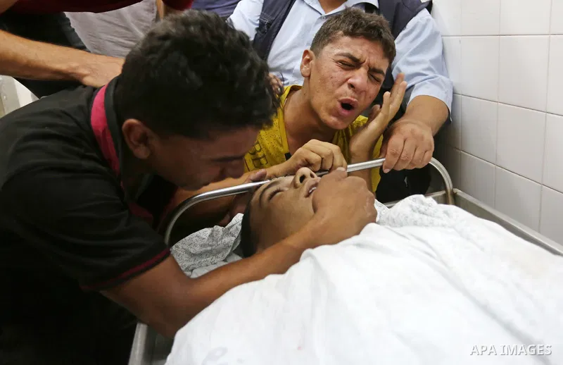 Relatives of Palestinian teenager Belal Khafaja, who was killed by Israeli forces during clashes in tents protest at the Israel-Gaza border, mourn over his body at a hospital in Rafah in the southern Gaza Strip on Septem...