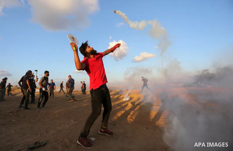 Palestinian protesters gather during clashes with Israeli troops in tents protest where Palestinians demand the right to return to their homeland at the Israel-Gaza border, in Khan Younis in the southern Gaza Strip on Se...
