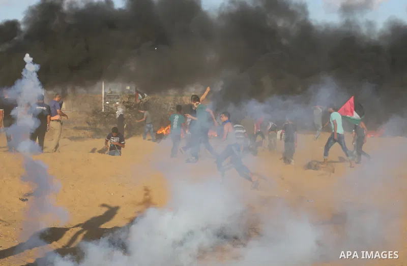 Palestinian protesters gather during clashes with Israeli troops in tents protest where Palestinians demand the right to return to their homeland at the Israel-Gaza border, in Khan Younis in the southern Gaza Strip on Se...