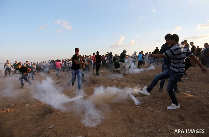 Palestinian protesters gather during clashes with Israeli troops in tents protest where Palestinians demand the right to return to their homeland at the Israel-Gaza border, in Khan Younis in the southern Gaza Strip on Se...