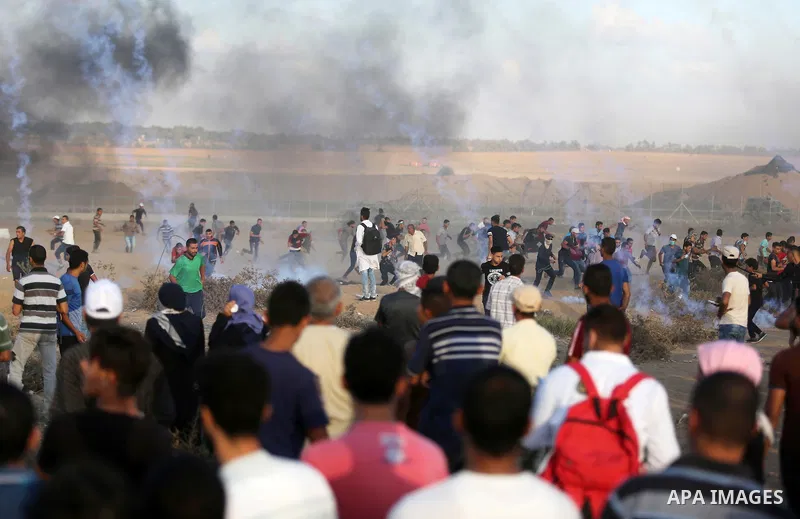 Palestinian protesters gather during clashes with Israeli troops in tents protest where Palestinians demand the right to return to their homeland at the Israel-Gaza border, in Khan Younis in the southern Gaza Strip on Se...