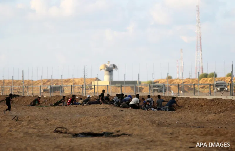 Palestinian protesters gather during clashes with Israeli troops in tents protest where Palestinians demand the right to return to their homeland at the Israel-Gaza border, in Khan Younis in the southern Gaza Strip on Se...