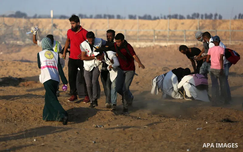 Palestinian protesters gather during clashes with Israeli troops in tents protest where Palestinians demand the right to return to their homeland at the Israel-Gaza border, in Khan Younis in the southern Gaza Strip on Se...