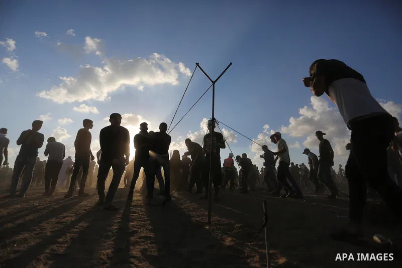 Palestinian protesters gather during clashes with Israeli troops in tents protest where Palestinians demand the right to return to their homeland at the Israel-Gaza border, in Khan Younis in the southern Gaza Strip on Se...