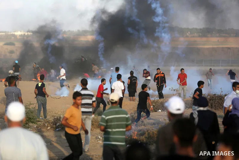 Palestinian protesters gather during clashes with Israeli troops in tents protest where Palestinians demand the right to return to their homeland at the Israel-Gaza border, in Khan Younis in the southern Gaza Strip on Se...