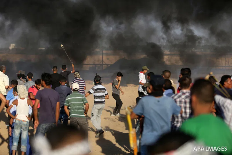 Palestinian protesters gather during clashes with Israeli troops in tents protest where Palestinians demand the right to return to their homeland at the Israel-Gaza border, in Khan Younis in the southern Gaza Strip on Se...