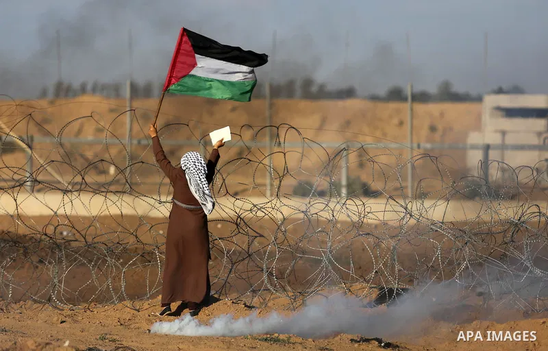 Palestinian protesters gather during clashes with Israeli troops in tents protest where Palestinians demand the right to return to their homeland at the Israel-Gaza border, in Khan Younis in the southern Gaza Strip on Se...