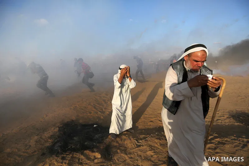 Palestinian protesters gather during clashes with Israeli troops in tents protest where Palestinians demand the right to return to their homeland at the Israel-Gaza border, in Khan Younis in the southern Gaza Strip on Se...