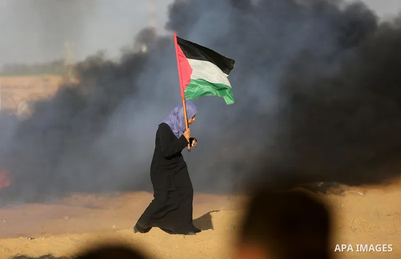 Palestinian protesters gather during clashes with Israeli troops in tents protest where Palestinians demand the right to return to their homeland at the Israel-Gaza border, in Khan Younis in the southern Gaza Strip on Se...
