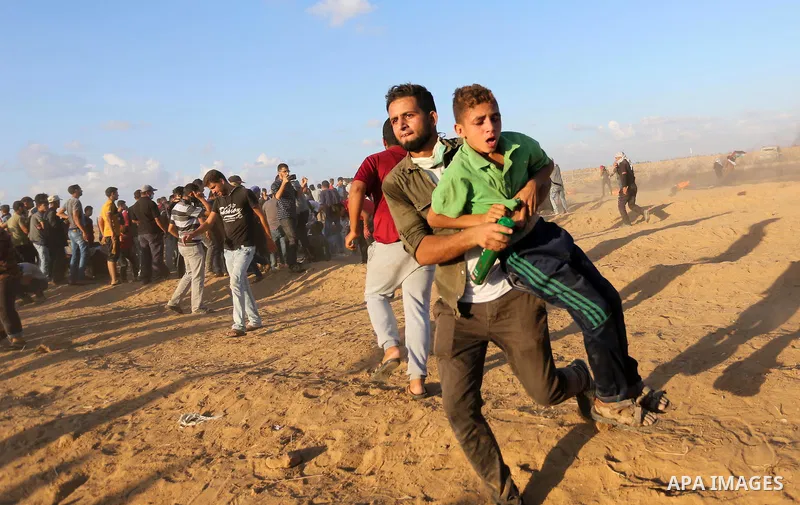 Palestinian protesters gather during clashes with Israeli troops in tents protest where Palestinians demand the right to return to their homeland at the Israel-Gaza border, in Khan Younis in the southern Gaza Strip on Se...