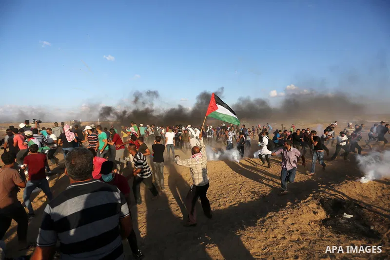 Palestinian protesters gather during clashes with Israeli troops in tents protest where Palestinians demand the right to return to their homeland at the Israel-Gaza border, in Khan Younis in the southern Gaza Strip on Se...