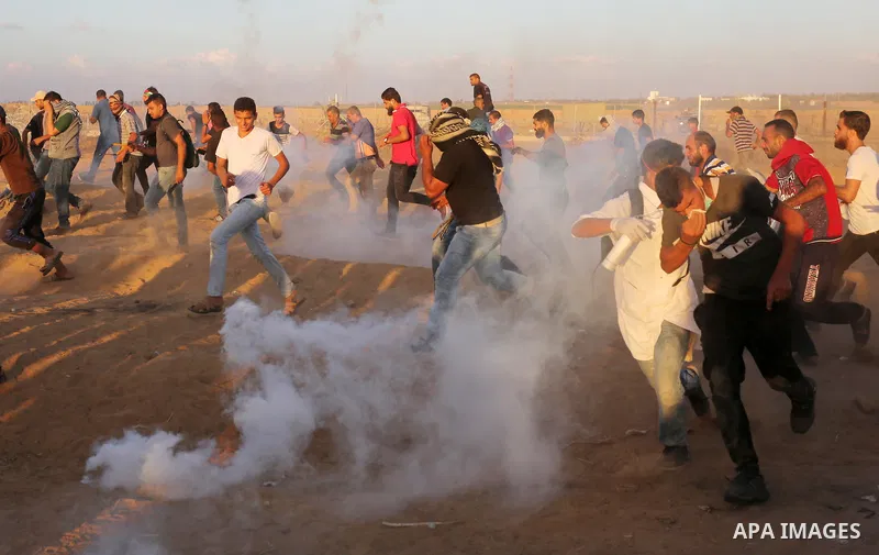 Palestinian protesters gather during clashes with Israeli troops in tents protest where Palestinians demand the right to return to their homeland at the Israel-Gaza border, in Khan Younis in the southern Gaza Strip on Se...