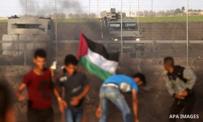 Palestinian protesters gather during clashes with Israeli troops in tents protest where Palestinians demand the right to return to their homeland at the Israel-Gaza border, in Khan Younis in the southern Gaza Strip on Se...