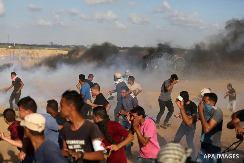 Palestinian protesters gather during clashes with Israeli troops in tents protest where Palestinians demand the right to return to their homeland at the Israel-Gaza border, in Khan Younis in the southern Gaza Strip on Se...