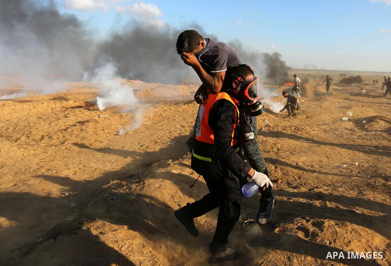 Palestinian protesters gather during clashes with Israeli troops in tents protest where Palestinians demand the right to return to their homeland at the Israel-Gaza border, in Khan Younis in the southern Gaza Strip on Se...